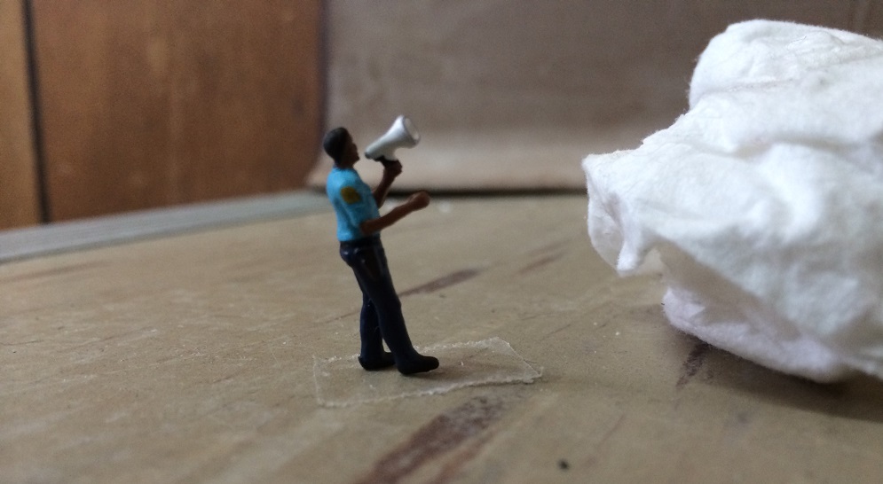 An officer calling to the tissue through a bullhorn.